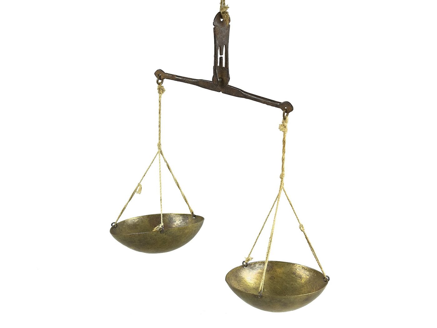 An antique brass balance scale of the kind historically used to weigh gold